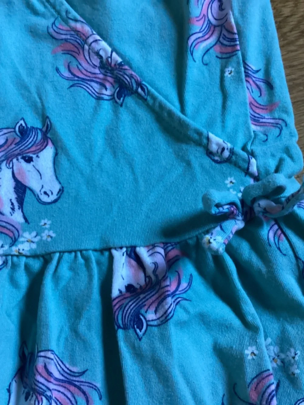 A Carter’s kid size 10 sage green dress with unicorns